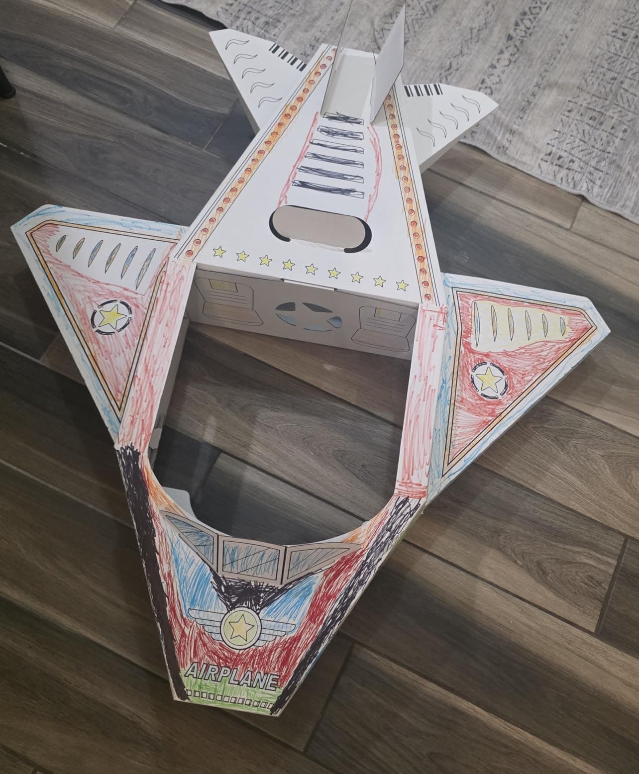 A family's colored-in cardboard airplane