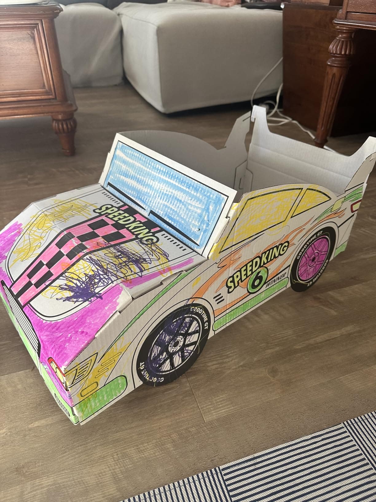 A family's colored-in cardboard car