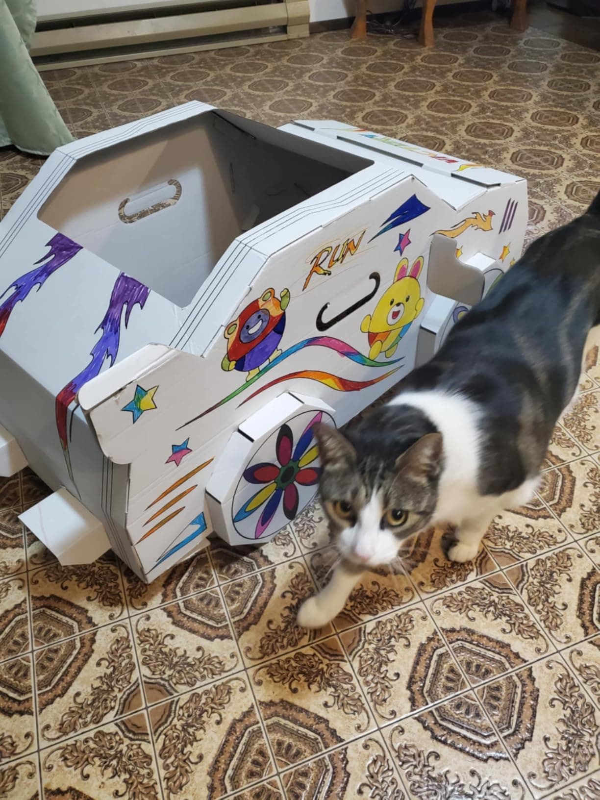 A family's colored-in cardboard car